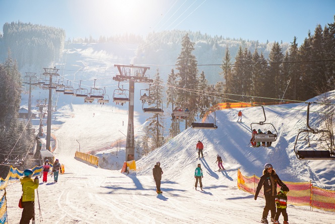 skiers-ski-lift-riding-up-ski-resort.jpg